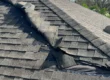 Hurricane damage from on a Florida Roof showing folded over shingles